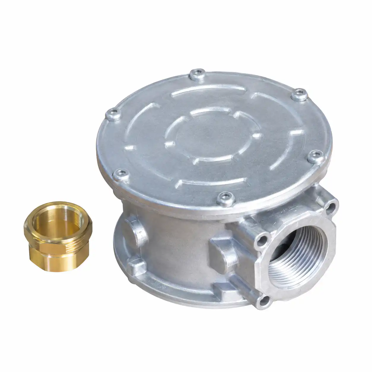 filter-za-gas-do-2-bar-dn32-1-1-4-03ac604 Srebrno metalno kućište sa okruglim poklopcem, zatvoreno zavrtnjima i navojima, pored odvojenog mesinganog priključka na beloj podlozi.